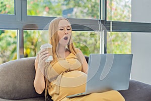 Tired pregnant woman at work drinks coffee caution advised due to potential harm of caffeine during pregnancy