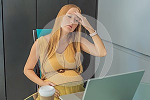 Tired pregnant woman at work drinks coffee caution advised due to potential harm of caffeine during pregnancy