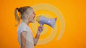 Tired preteen girl shouting in megaphone, relieving stress, children rights