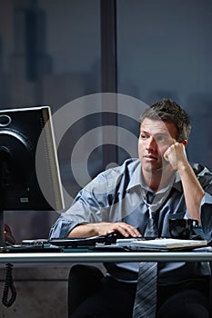 Tired professional looking at screen troubled
