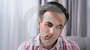 Tired sad man looking at camera. Male unhappy face. Disappointed guy portrait.