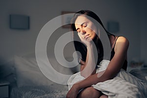 Tired and Sad Woman Sitting in her Bedroom Alone