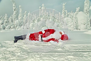 Tired Santa Claus fell asleep in the open air.