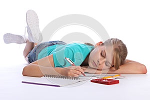 Tired school girl falls asleep doing math homework