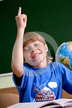 Tired schoolboy with his hand up