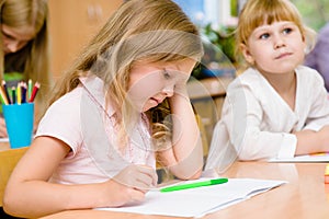 Tired schoolgirl in classroom