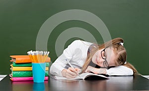 Tired schoolgirl spoils the eyesight during the exam