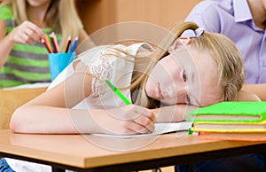 Tired schoolgirl spoils the eyesight during the exam