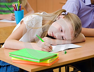 Tired schoolgirl spoils the eyesight during the exam