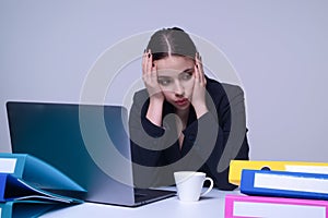 Tired secretary. Overworked Business woman. Busy working. Feeling tired and stressed. Frustrated young woman sitting at