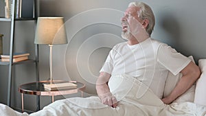 Tired Senior Old Man having Back Pain in Bed