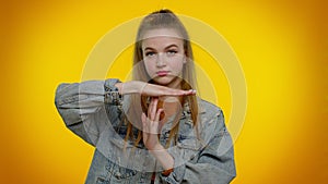 Tired serious teen girl showing time out gesture, limit or stop sign, no pressure, i need more time