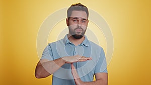 Tired serious upset caucasian man showing pause gesture, stop sign, time out, relax, break, deadline