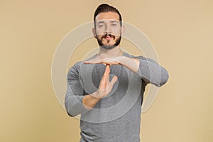 Tired serious upset lebanese man showing pause gesture, stop sign, time out, relax, break, deadline