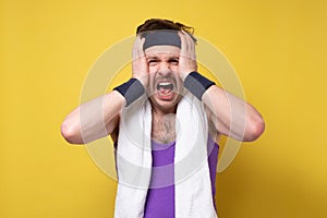 Tired sick fitness sporty guy put hands on head, having headache