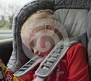 Tired sleeping child in car