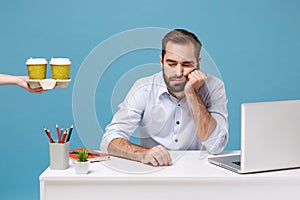 Tired sleeping man work at desk with pc laptop isolated on blue background. Food products delivery courier service from