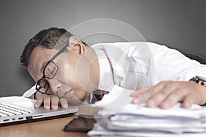 Tired Sleepy Asian Businessman Having Overworked