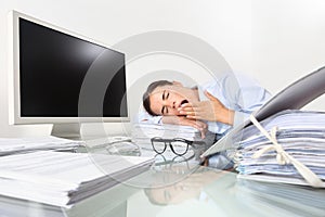 Tired sleepy business woman yawning, working at office desk in f