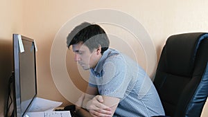 Tired sleepy man working at computer.