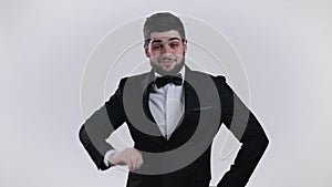 Tired sleepy man yawns. Lazy guy with beard in tuxedo showing emotion of very boring, uninteresting,. White studio