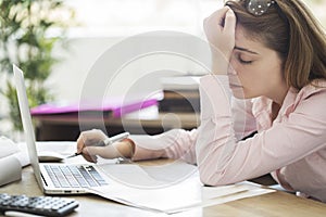 Tired and sleepy woman working on computer