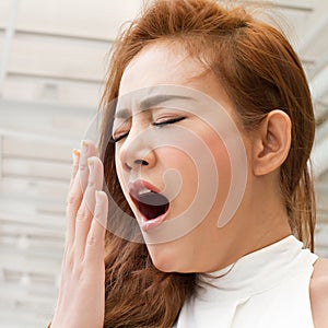 Tired, sleepy woman yawning with fatigue