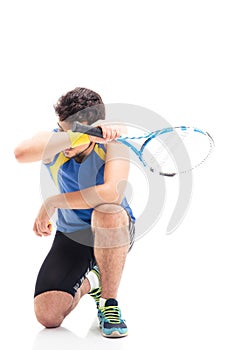 Tired sports man with tennis racket