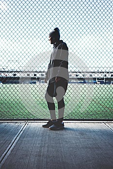 Tired sportsman leaned and holding on to the rabitz fence