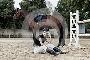 Tired sportsman. Rider sitting after race