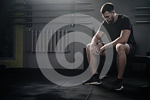 Tired Sportsman Sit on Bench After Workout .