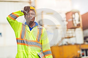 Tired stress worker sweat from hot weather in summer working in port goods cargo shipping logistic ground,  Black African race