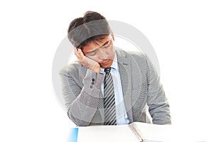 Tired and stressed Asian businessman