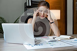 Tired stressed business woman suffering from headaches while working from home office