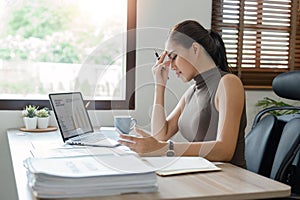 Tired stressed business woman suffering from headaches while working from home office