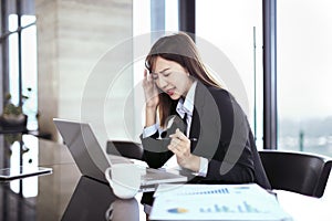 Tired and stressed business woman working in