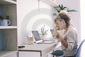 Tired stressed middle age business woman suffering from neckpain working from home office sitting at table. Overworked adult lady