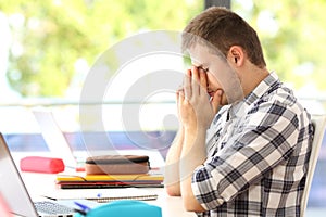 Tired student alone in a classroom