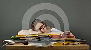 Tired student with glasses sleeping on books in the library