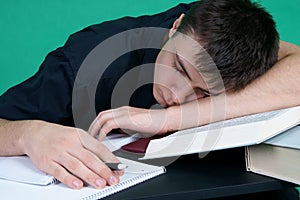 Tired student sleeping at the desk
