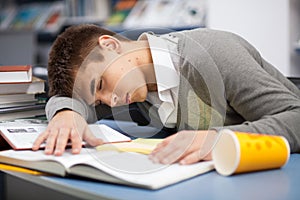 Tired student sleeping at the desk