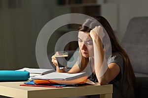 Tired student studying late hours drinking coffee photo