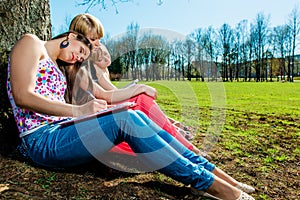 Tired students sleeping outdoors