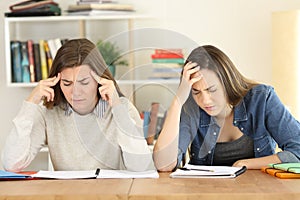 Tired students studying hard at home