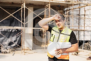 Tired Sweating Construction Worker On Building Site Under Sunlight