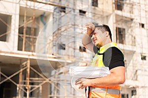 Tired Sweating Construction Worker On Building Site Under Sunlight