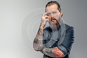 Tired man with beard and tattooes