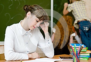 Tired teacher in classroom