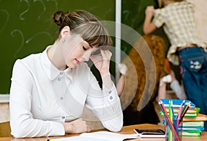 Tired teacher in classroom photo