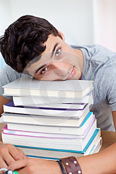 Tired teeenager sleeping in a library